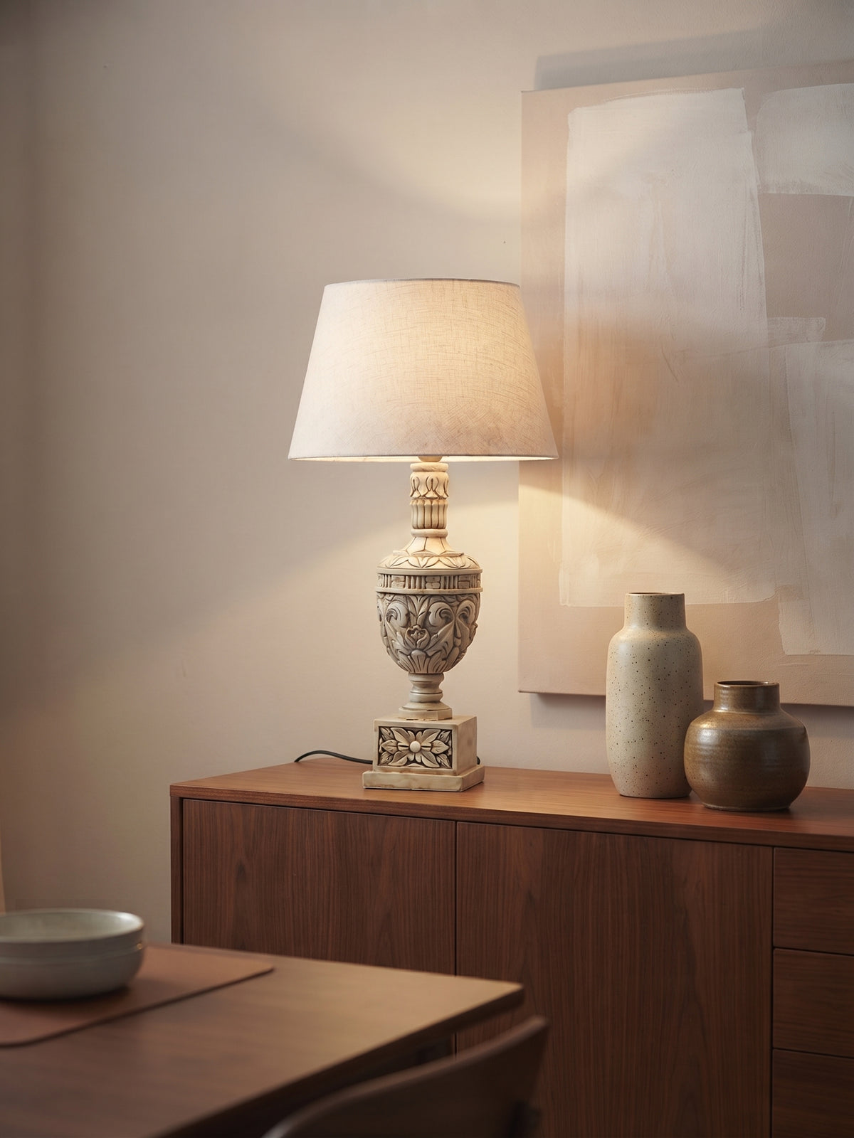 Bellora Sculptural Table Lamp styled on a console table with books, artwork and warm neutral decor