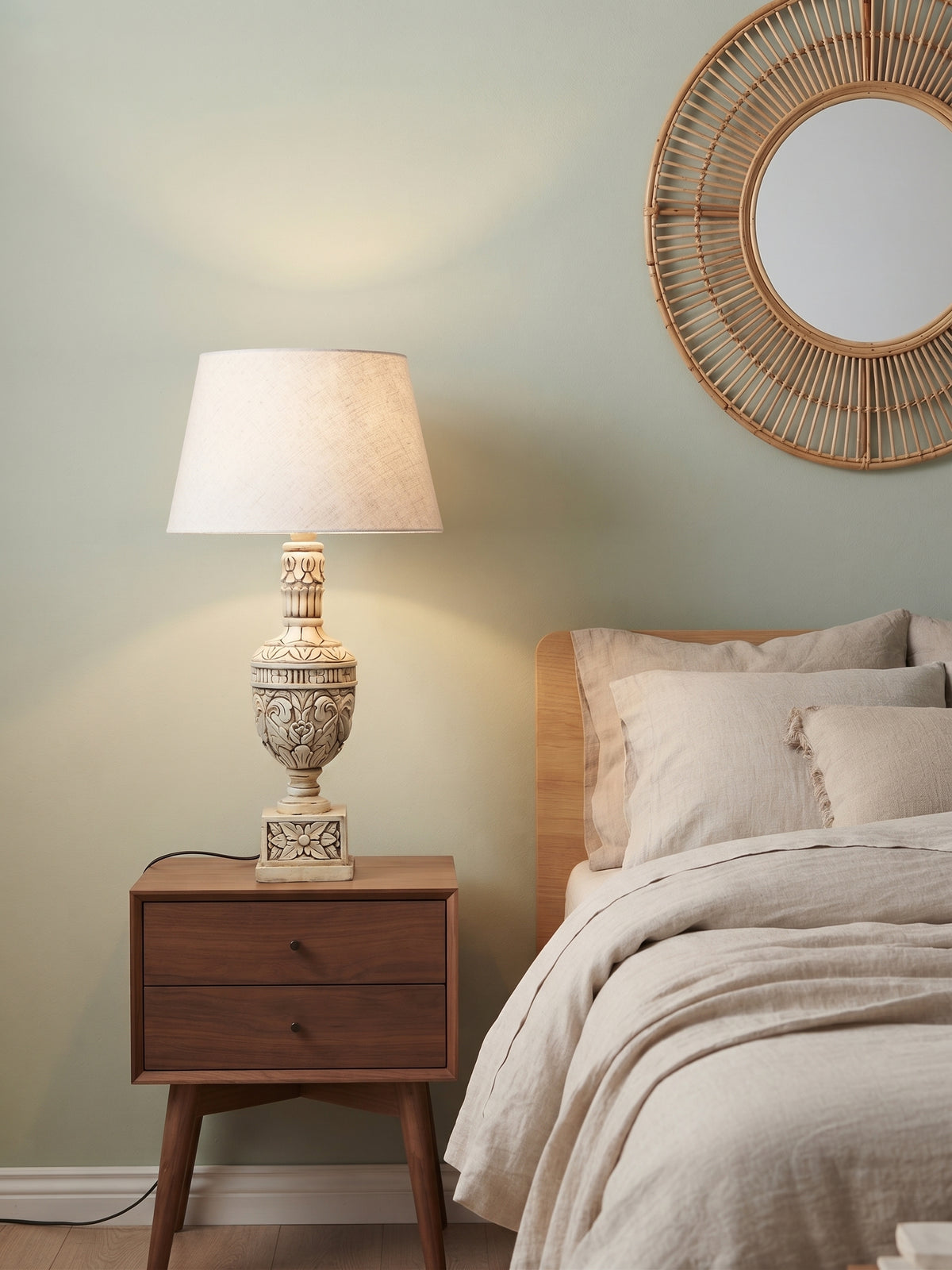 Bellora Sculptural Table Lamp styled on a bedside table in a warm neutral bedroom
